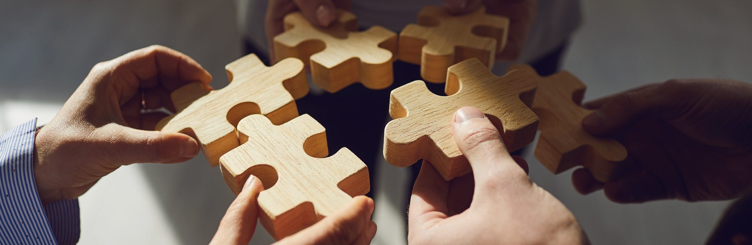 Crop coworkers idea stacking wooden puzzles together